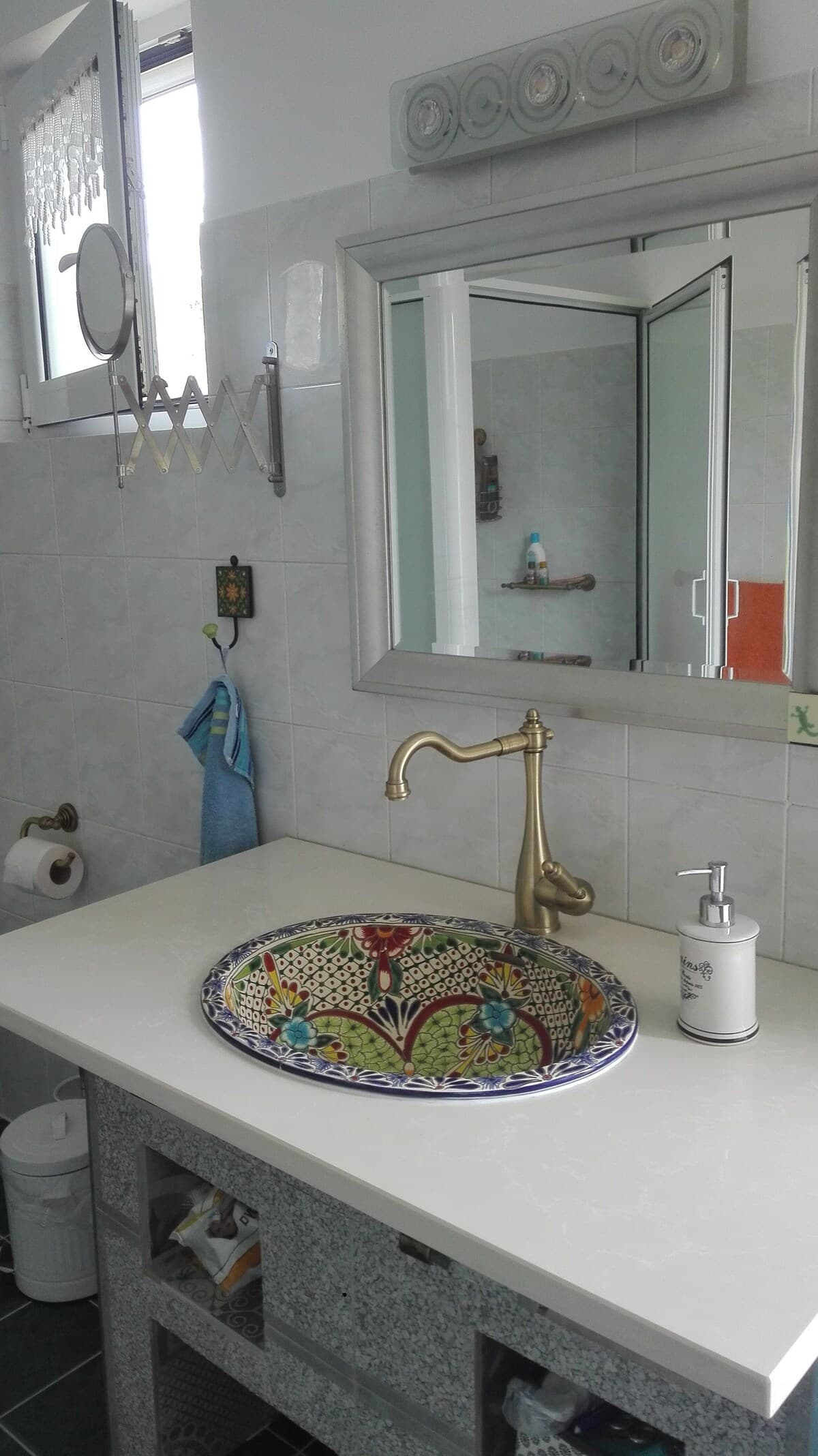Bathroom with hand-painted ceramic basin and brass faucet