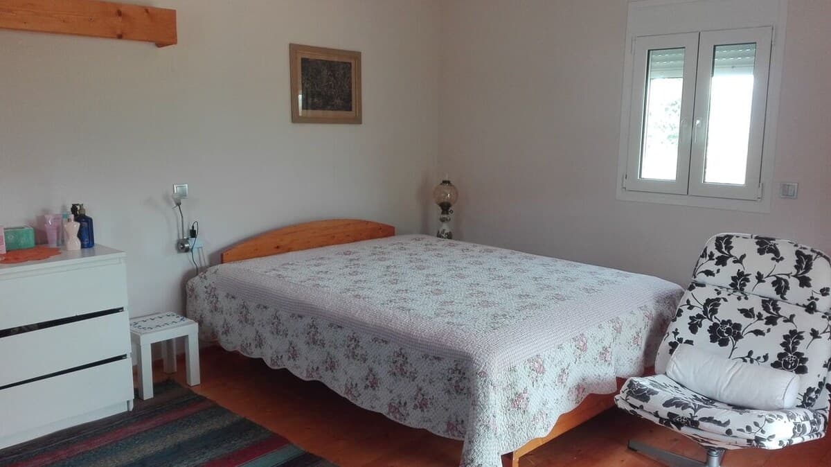 Bedroom with double bed and floral bedspread