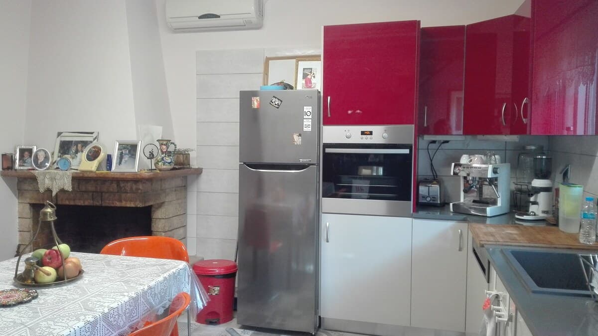 Kitchen with stone fireplace, modern appliances, and AC