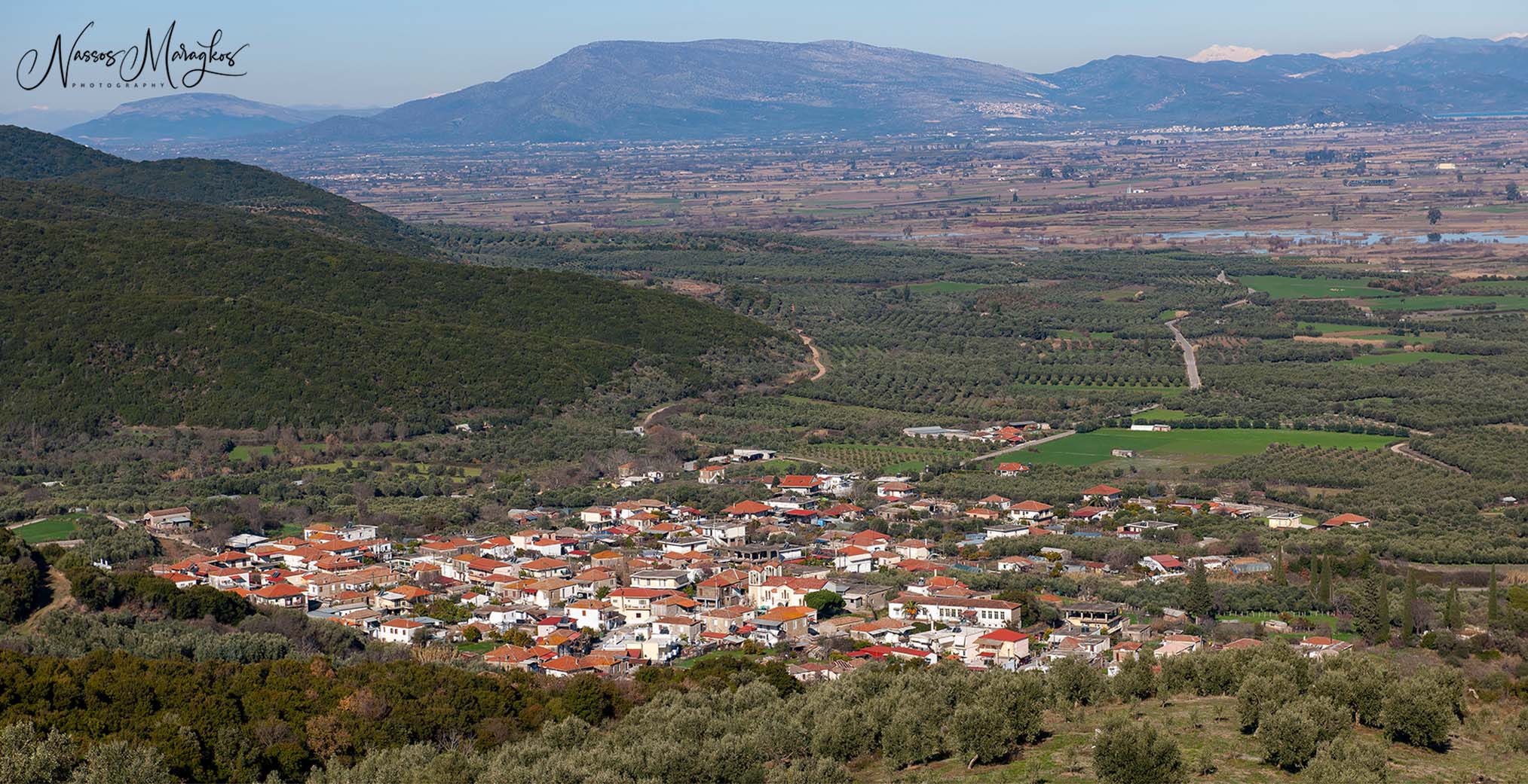 Lysimachia village from above — red rooftops and mountains